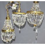 A group of three cut glass and gilt metal chandeliers, comprising one of bag form and two Empire