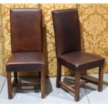 A pair of leather hall chairs, of late 20th century design, the dark brown leather upholstery with
