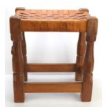 A Robert "Mouseman" Thompson oak stool with intertwined leather seat, with carved mouse to the