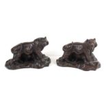 A pair of bronzed resin tigers, each signed to the back M. W. Pierce.