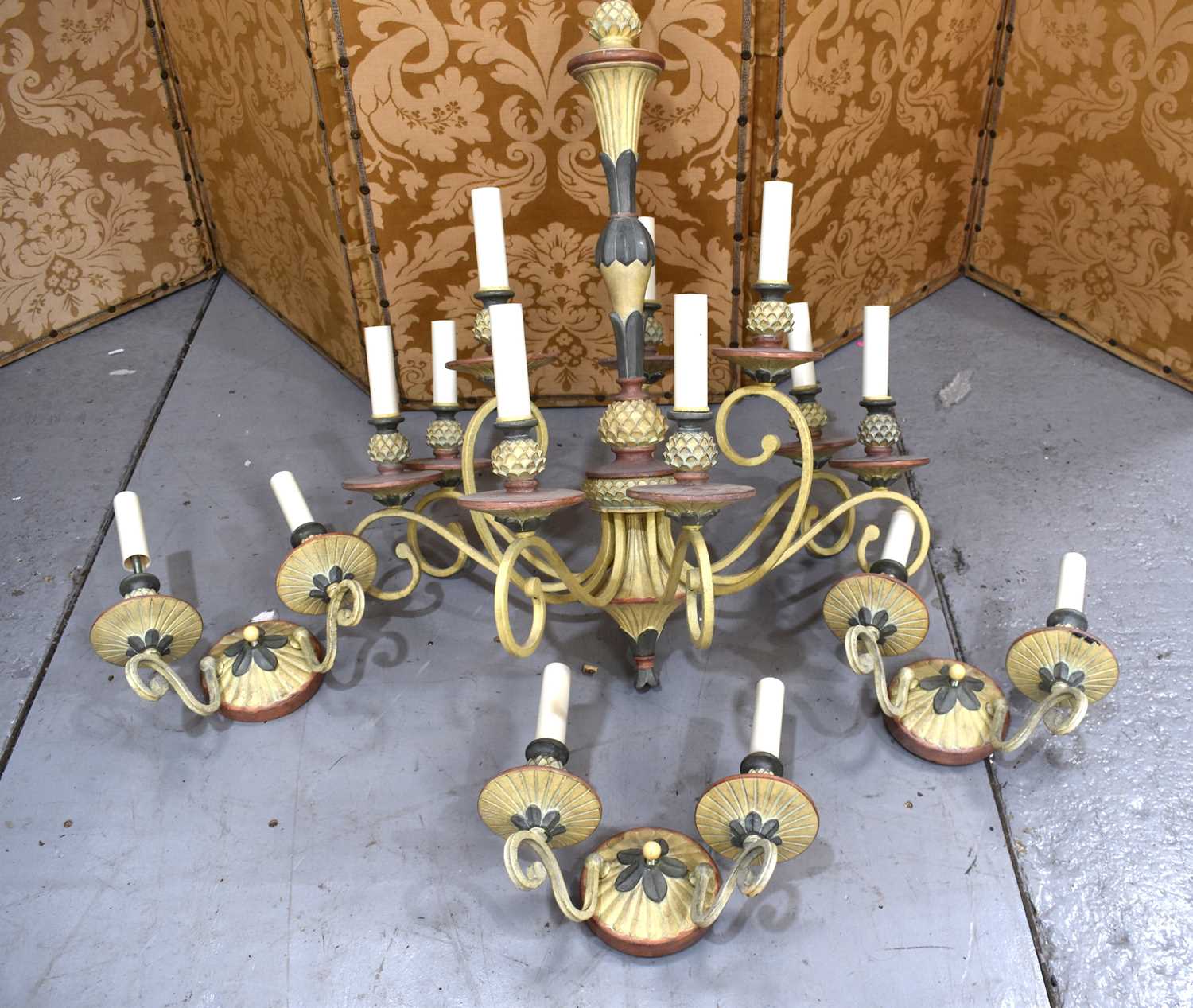 A French style painted metal chandelier, with nine scrolling arms raising candle bulb sockets,