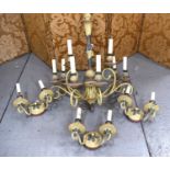 A French style painted metal chandelier, with nine scrolling arms raising candle bulb sockets,