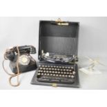 A Vintage Remington typewriter, together with a vintage telephone, later adapted and a desk model of