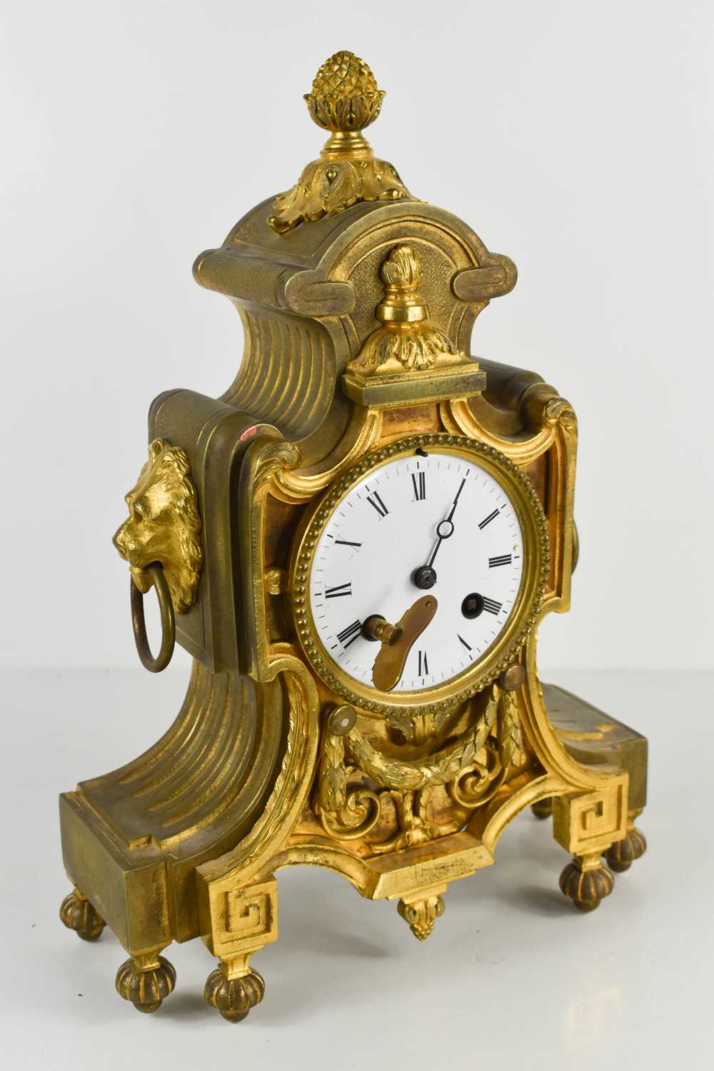 A French 19th century gilt metal mantle clock, with enamel Roman Numeral dial, and two lion head and - Image 2 of 2