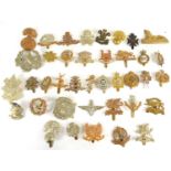 A group of Victorian and later military cap badges to include Royal Suffolk Hussars, Royal