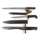 Three military bayonets, two with metal scabbards and serial numbers.