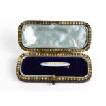 A 14ct gold, turquoise enamel and seed pearl brooch of marquise form, the seed pearls set to the