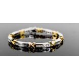 An 18ct white & yellow gold and diamond bracelet, designed as series of eight diamond set white