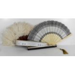 Two antique fans, one with white ostrich feathers and faux tortoiseshell, the other in bone and