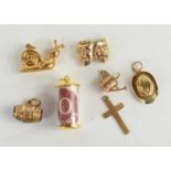 A group of six 9ct gold charms, comprising a snail, watering can, theatrical masks, a stetson and