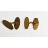 A pair of 9ct gold cufflinks of oval form, with machine engraved decoration, 4.77g.