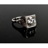 An Art Deco style diamond and platinum dress ring, the central brilliant cut stone of