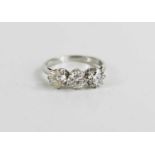 A platinum and three stone diamond ring, the brilliant cut diamonds each approximately 0.65cts, in