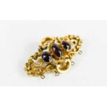 A 19th century rolled gold and garnet three stone brooch.