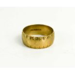 A 9ct gold wedding band, with engraved decoration to the edges, size V, 5.86g.