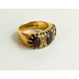 A vintage 9ct gold garnet dress ring the three oval garnets interspersed with two rows of three