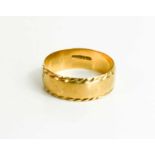 A 9ct gold wedding band with rope twist decoration to the edge, size Y, 4.65g. It shows some signs