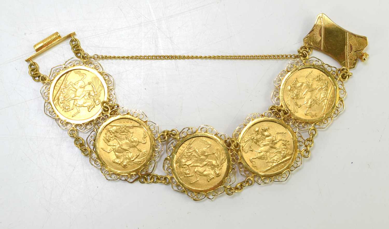 An 18ct gold sovereign bracelet set with five George V full gold sovereigns, all dated 1917 and with