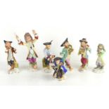 A group of seven Meissen style ceramic figures of monkeys in an orchestra, comprising of a French