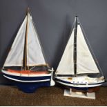 Two hand built pond yachts, painted and rigged, one with stand.