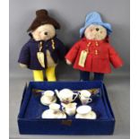 A group of children's toys, comprising two Paddington Bears and a child's tea set.