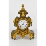 A French 19th century gilt metal mantle clock, with enamel Roman Numeral dial, and two lion head and