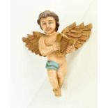 A 20th century polychrome winged cherub, 29cm high.