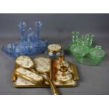 A selection of mid-century coloured glass dressing table sets, together with a metal example