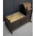 An 18th century oak cradle, with later Victorian carvings, with tin-lined jardiniere insert, 90cm by