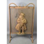 An antique wrought iron fire guard, the centre of the screen with a cast figure of a gentleman