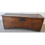A 17th century boarded oak coffer with iron lock plate, the single plank top having a moulded