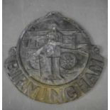 A reproduction lead insurance plaque, moulded with a fireman and pump with above Birmingham.