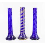 Three Victorian blue glass swirl vases.