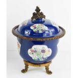 A 19th century Chinese style pot and cover, the blue ground with fan and quatrafoil cartouches