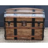 A 19th century steamer trunk, the domed top opening to reveal a paper lining, iron lock plate, and