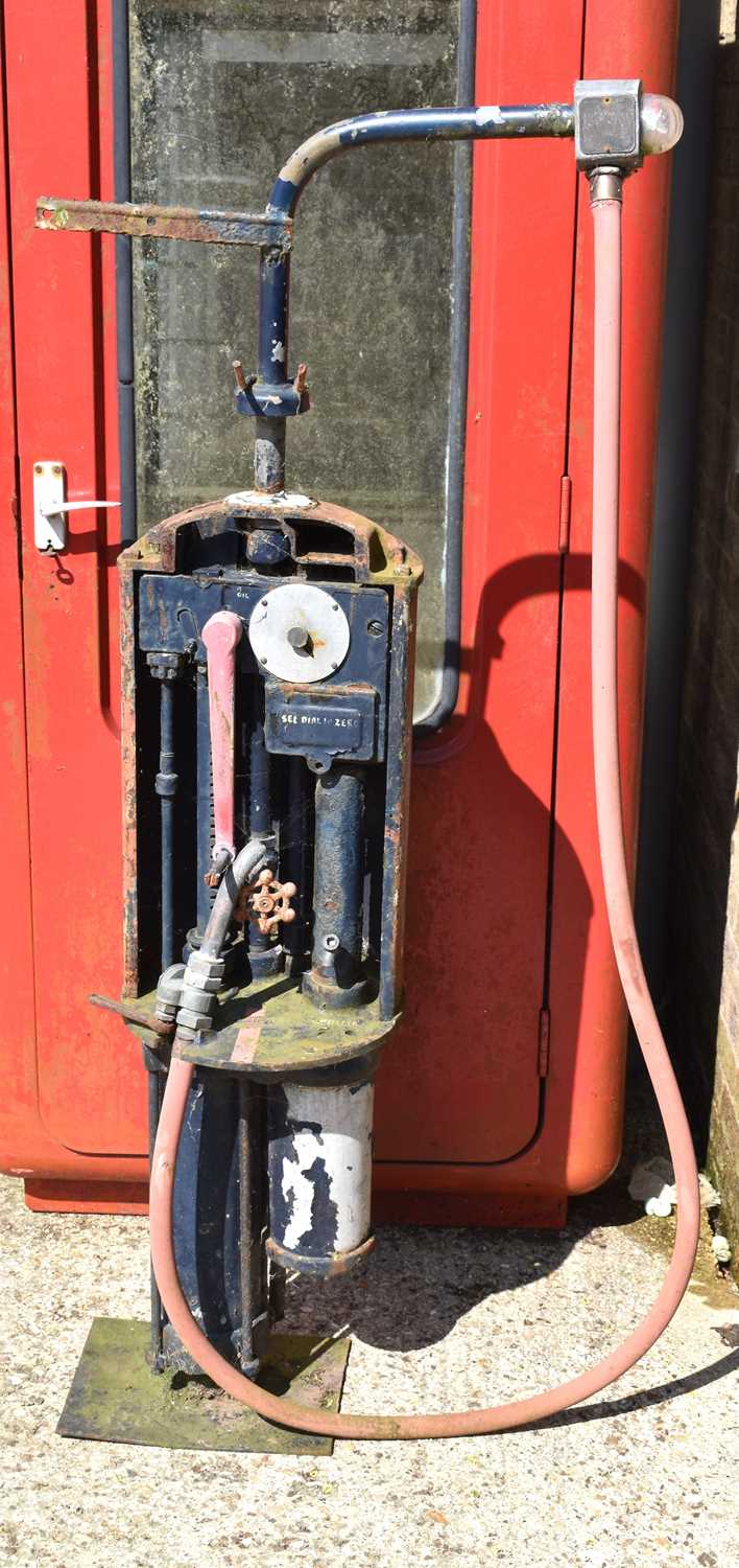 A vintage hand operated Redline petrol pump, missing globe.