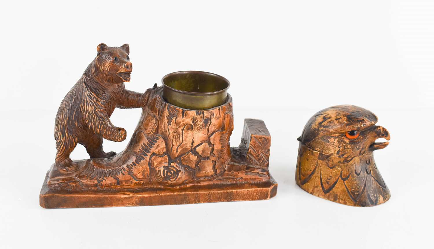 A Blackforest style inkstand, together with an inkwell in the form of an eagle head.