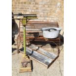 A metal garden bench together with two pig troughs, vintage scales, galvanised bath and other items.
