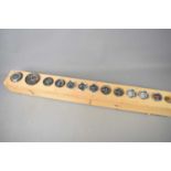 A collection of vintage car dials mounted on a wooden board to include Alfa Romeo and possibly