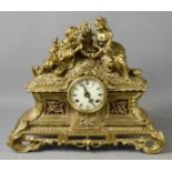 A 20th century French style Imperial brass mantle clock, the Roman Numeral dial surmounted by two