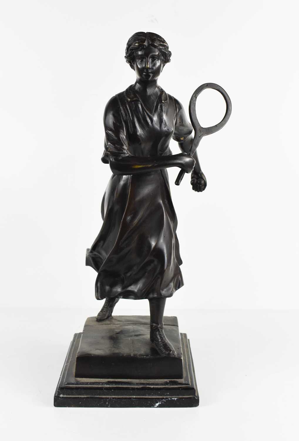 E. Loisauy: a bronze figure of a female tennis player, on a stepped base, signed to the back, 41cm