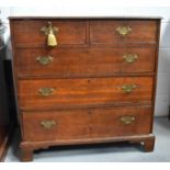 A 19th century oak chest of drawers, the two over three long graduated drawers raised on bracket
