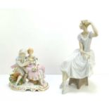 A Lladro figure of a ballerina, and an early 20th century figure group of a courting couple, with