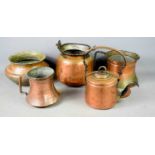 A group of copper on metal vessels of various for, two with single applied handles, a kettle with