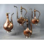 A group of three Iranian/Middle Eastern copper silvered coffee pots, tallest 40cm high, with