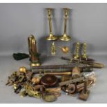 A group of various metal wares including brass candlesticks, door knockers and handles.