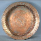 A large Iranian/Middle Eastern silvered copper shallow bowl or charger of sloped circular form,
