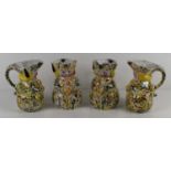 A group of four Victorian Toby Jugs each with a polychrome lustre speckle glaze, 13cm high.