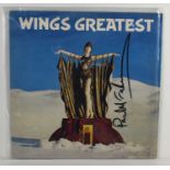 A Wings Greatest Hits vinyl record, signed to the front by Paul McCartney.