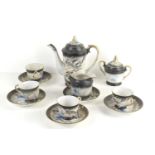 A vintage Japanese Dragonware tea set with raised dragon decoration and gilded handles, the set